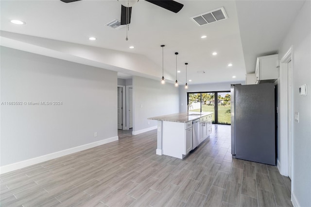 kitchen with appliances with stainless steel finishes, light wood-type flooring, a center island, hanging light fixtures, and white cabinetry