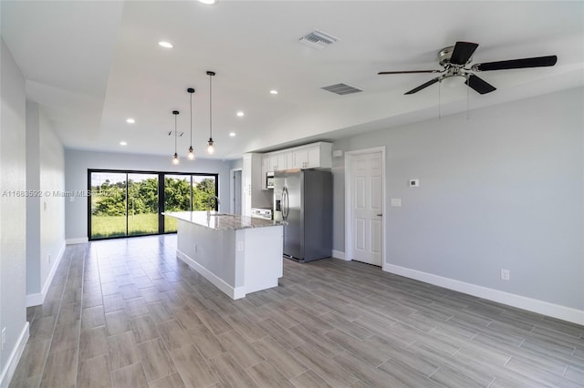 kitchen featuring a kitchen island, white cabinetry, pendant lighting, light hardwood / wood-style flooring, and stainless steel refrigerator with ice dispenser