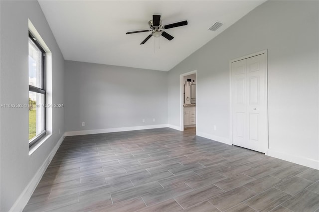 empty room featuring lofted ceiling, light hardwood / wood-style flooring, and ceiling fan