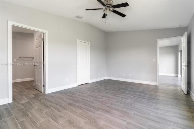 unfurnished bedroom with light hardwood / wood-style flooring, a closet, lofted ceiling, and ceiling fan