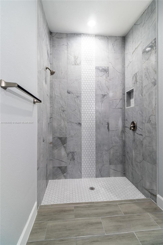 bathroom with a tile shower