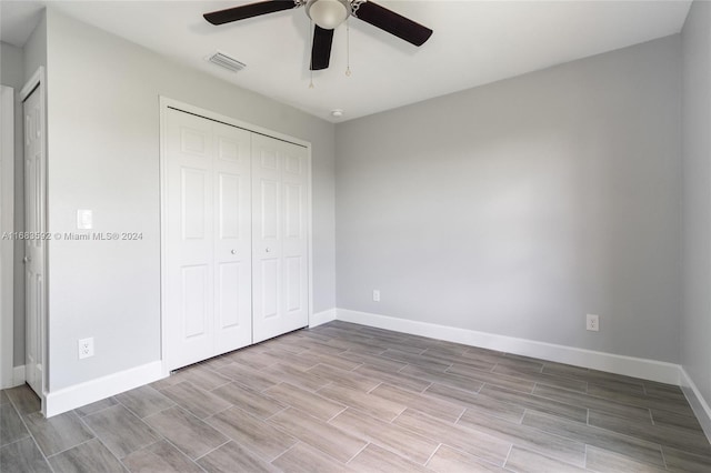 unfurnished bedroom featuring a closet and ceiling fan