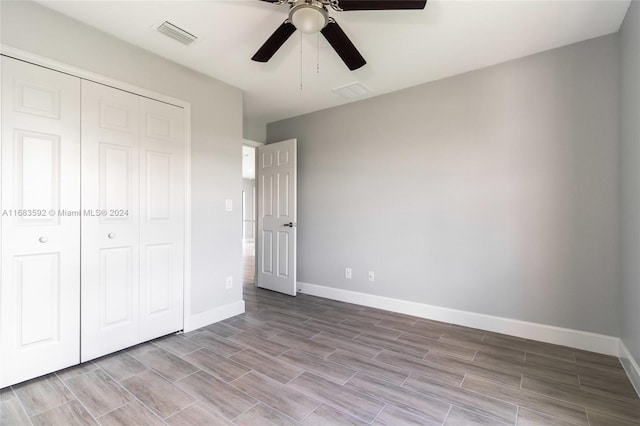 unfurnished bedroom with a closet and ceiling fan