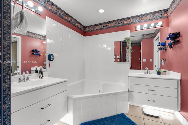 bathroom with vanity, a relaxing tiled tub, and tile patterned flooring