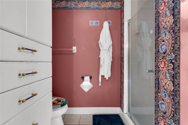 bathroom featuring toilet, walk in shower, and tile patterned floors