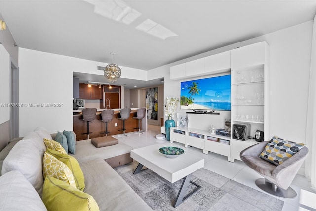 tiled living room with an inviting chandelier