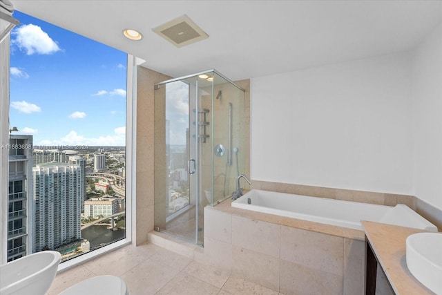 full bathroom with toilet, tile patterned flooring, independent shower and bath, a bidet, and vanity