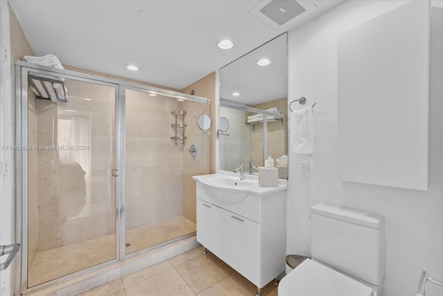 bathroom with vanity, tile patterned flooring, toilet, and an enclosed shower