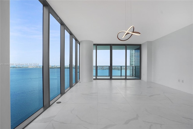 empty room with a water view and floor to ceiling windows