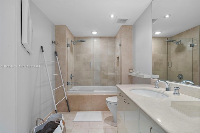 full bathroom with vanity, combined bath / shower with glass door, toilet, and tile patterned flooring