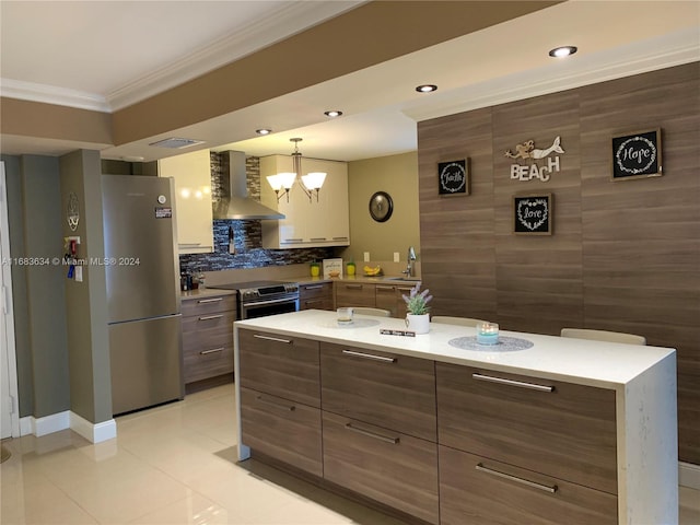 kitchen with wall chimney exhaust hood, stainless steel appliances, decorative light fixtures, light tile patterned floors, and a chandelier