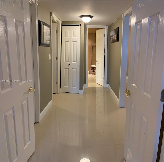 hallway with light tile patterned floors