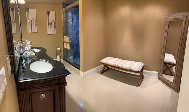 bathroom with vanity and a shower with door