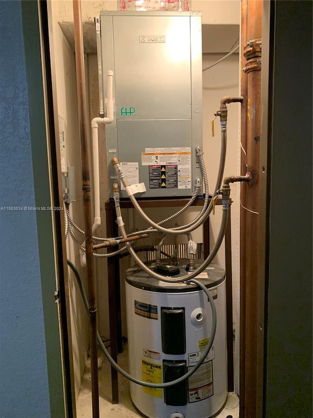 utility room featuring electric water heater