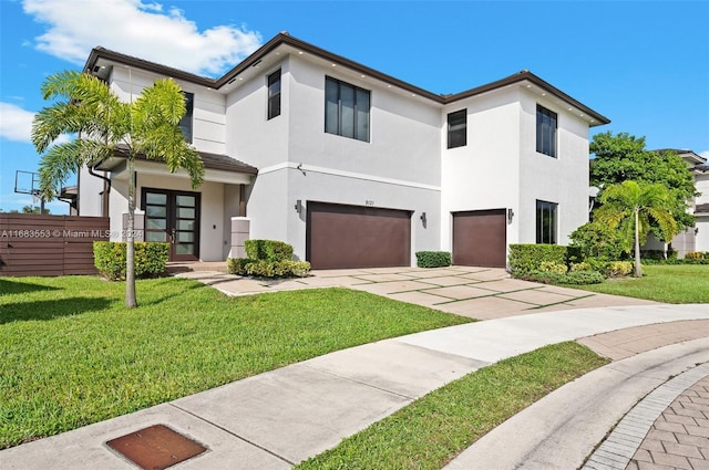 view of front of house featuring a front lawn and a garage