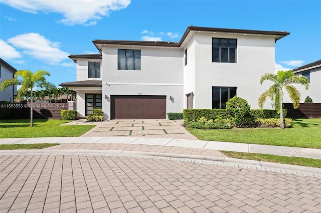 view of front of property with a front yard and a garage