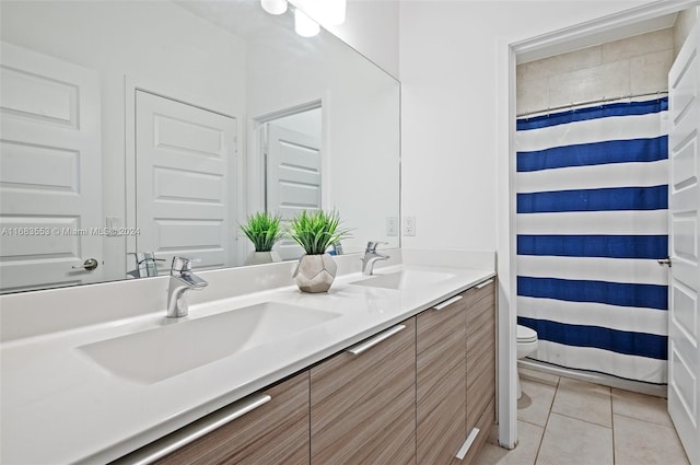 bathroom with toilet, walk in shower, vanity, and tile patterned flooring