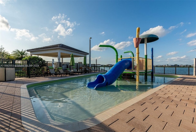 view of pool featuring a gazebo, a patio area, a playground, and a water view