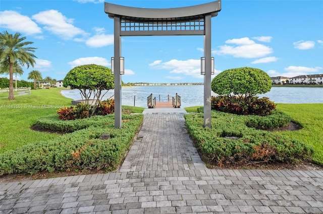 view of property's community featuring a water view and a lawn