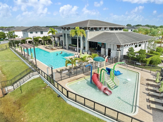 view of pool with a patio and a yard