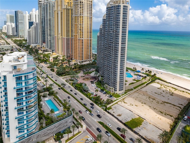 drone / aerial view with a water view and a beach view