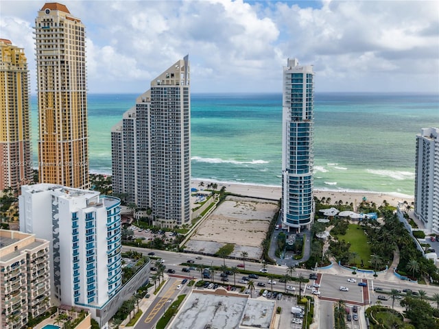 bird's eye view featuring a water view and a view of the beach