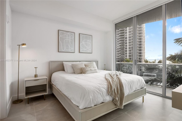 bedroom with access to outside and tile patterned floors