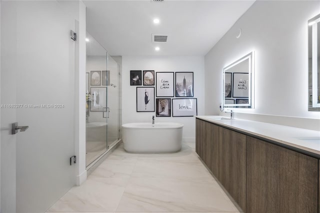 bathroom with vanity and independent shower and bath