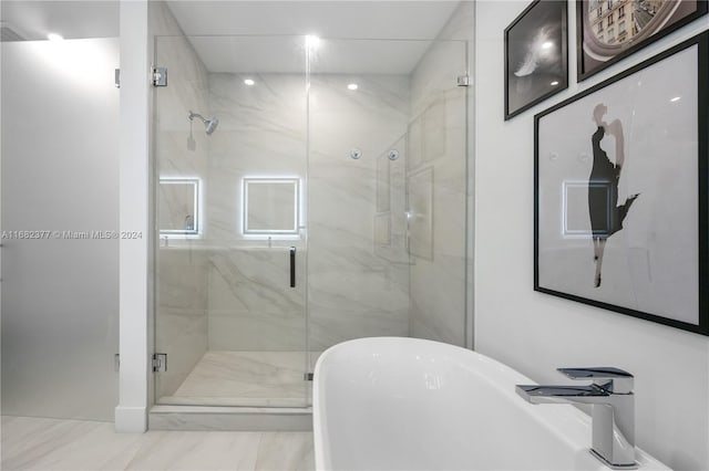 bathroom featuring separate shower and tub and sink