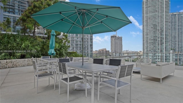 view of patio featuring a city view and outdoor dining area