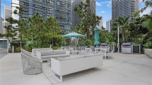 view of patio with an outdoor hangout area, a view of city, and outdoor dining area