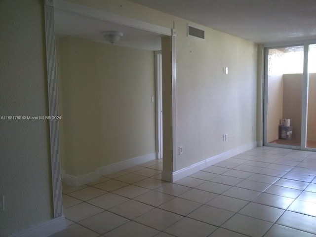 unfurnished room with light tile patterned floors