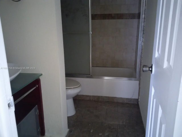 full bathroom with vanity, toilet, and combined bath / shower with glass door