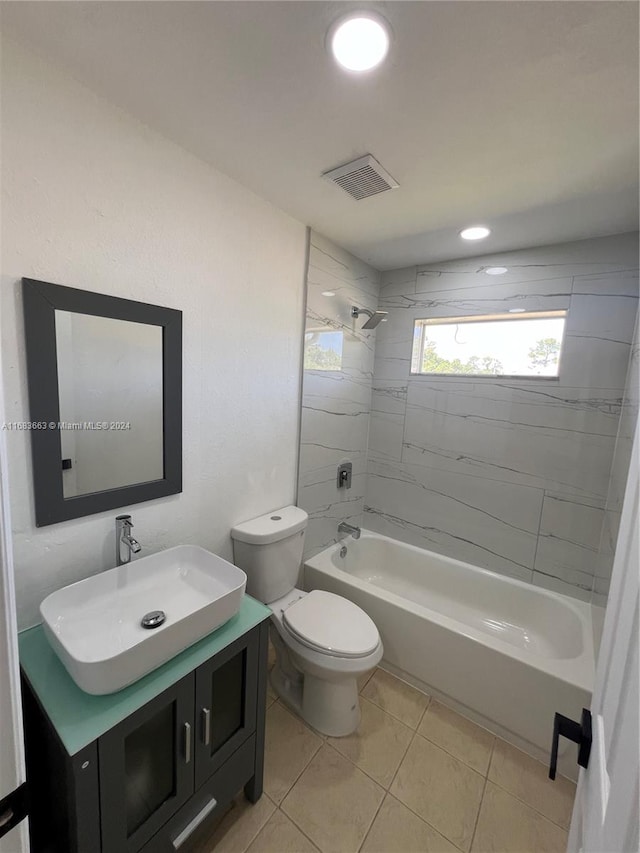 full bathroom with tiled shower / bath, vanity, toilet, and tile patterned flooring