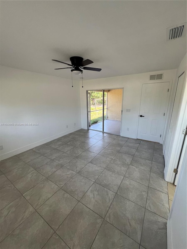 unfurnished bedroom featuring ceiling fan, light tile patterned floors, and access to exterior