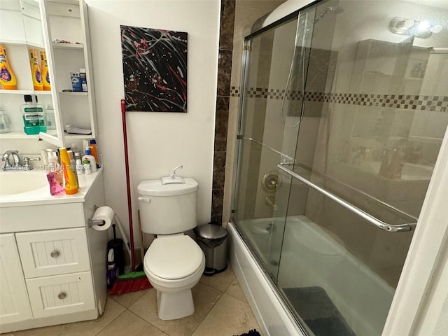 full bathroom featuring vanity, bath / shower combo with glass door, toilet, and tile patterned flooring