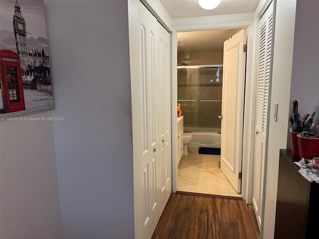 hallway with hardwood / wood-style floors