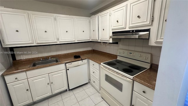 kitchen with white cabinetry, sink, light tile patterned floors, and white appliances