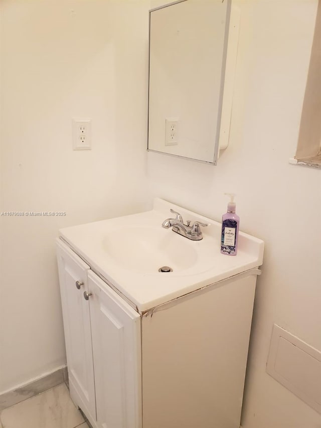 bathroom featuring marble finish floor and vanity