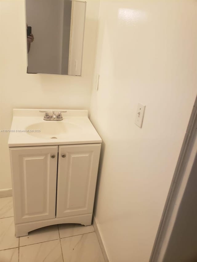 bathroom with vanity and baseboards