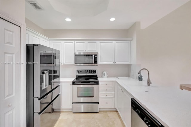 kitchen with white cabinetry, sink, light tile patterned floors, and stainless steel appliances