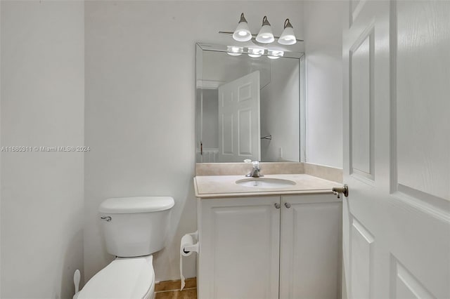 bathroom with vanity, tile patterned floors, and toilet