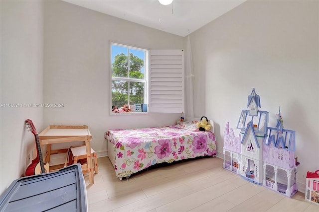 bedroom with light hardwood / wood-style flooring and vaulted ceiling