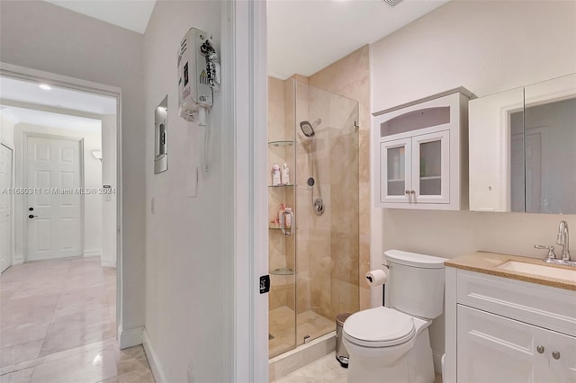 bathroom with an enclosed shower, vanity, tile patterned floors, and toilet