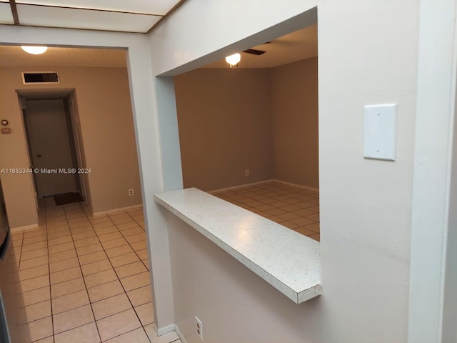 corridor featuring light tile patterned flooring