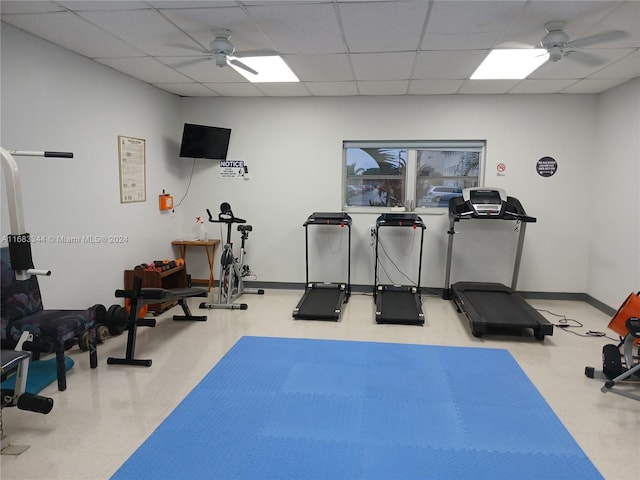 workout area featuring a paneled ceiling and ceiling fan