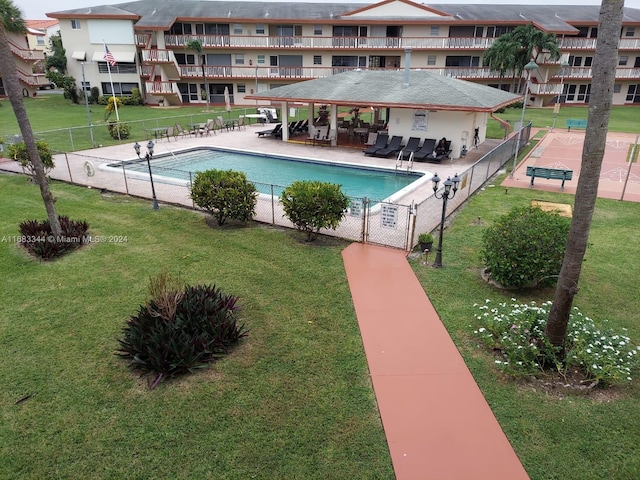 view of swimming pool with a yard and a patio area