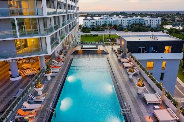 view of pool at dusk