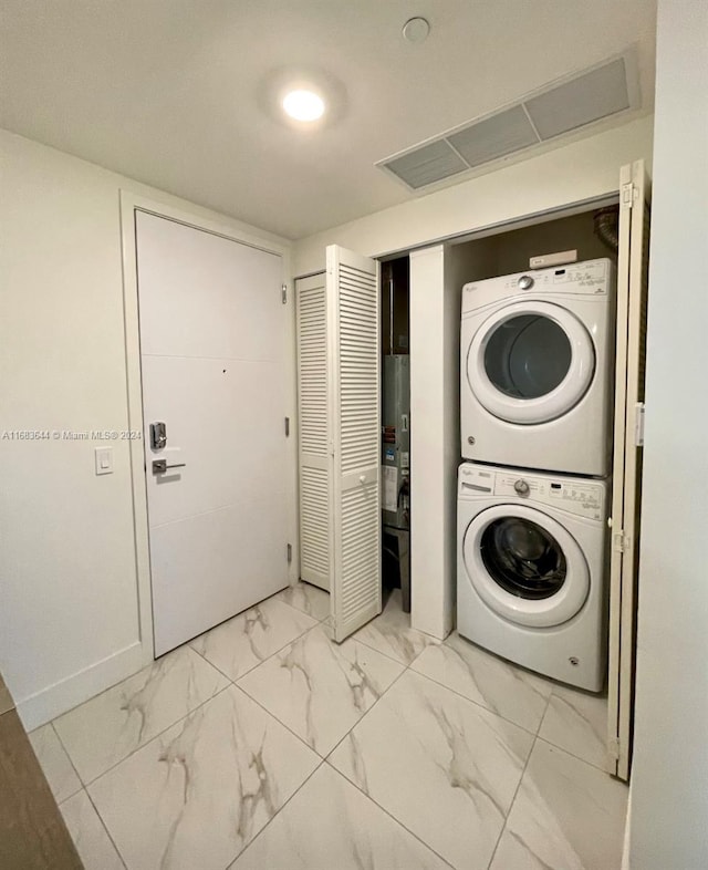 laundry area featuring stacked washer and dryer