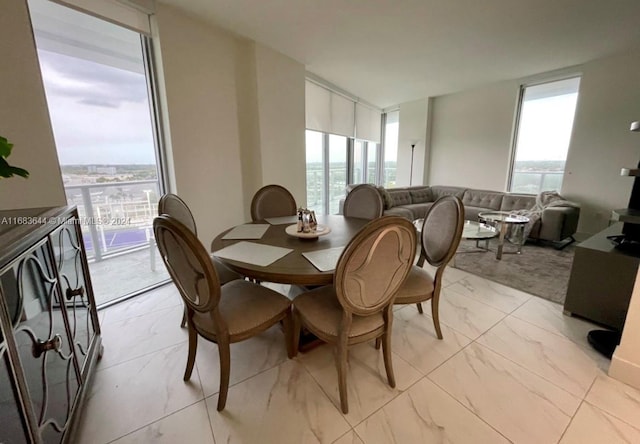 dining area with a healthy amount of sunlight and floor to ceiling windows